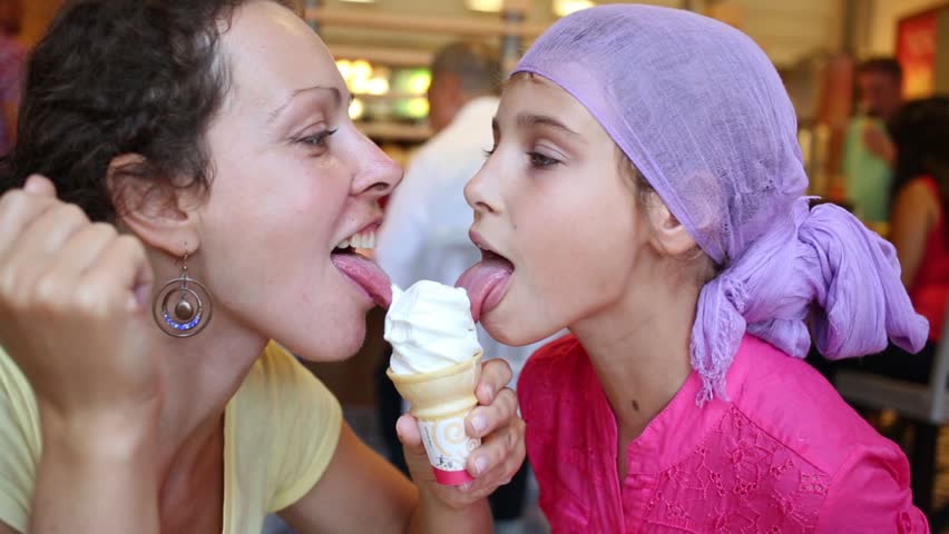 mom and daughter licking