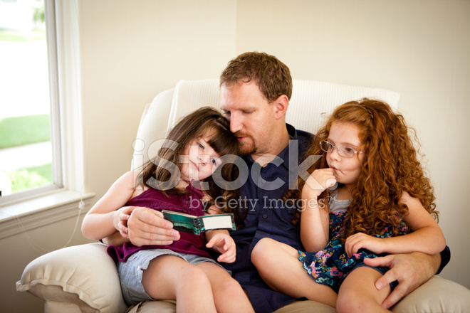 daughter sits on dads lap